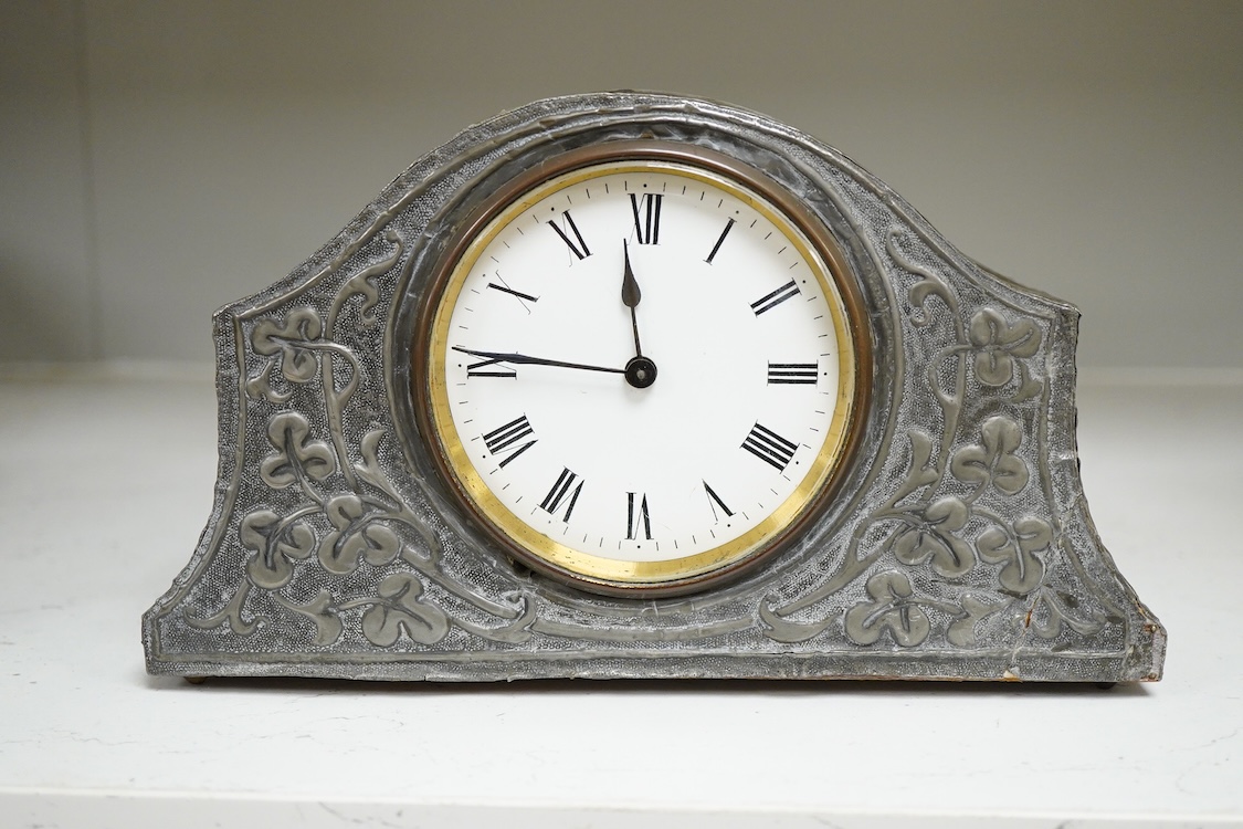 A pewter mantel timepiece with key, 22cm wide